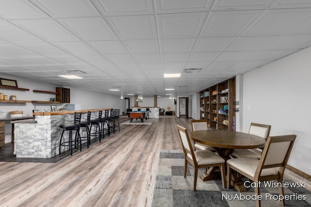 3732 E 128th St, Grant, MI 49327 - dining room featuring a community bar, wood finished floors, and baseboards