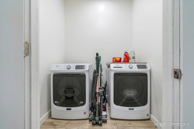 1200 Iroquois Trl, Hastings, MI 49058 - laundry room with washing machine and clothes dryer, wood finished floors, and baseboards