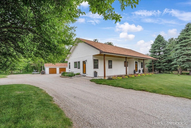 1200 Iroquois Trl, Hastings, MI 49058 - view of front of house featuring a front lawn and gravel driveway