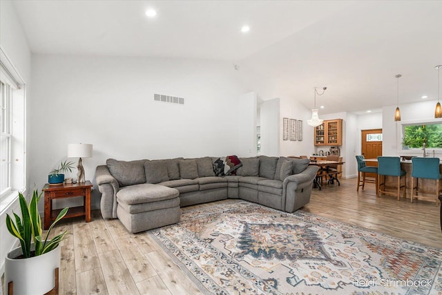 1200 Iroquois Trl, Hastings, MI 49058 - living room featuring light wood-type flooring, vaulted ceiling, and recessed lighting