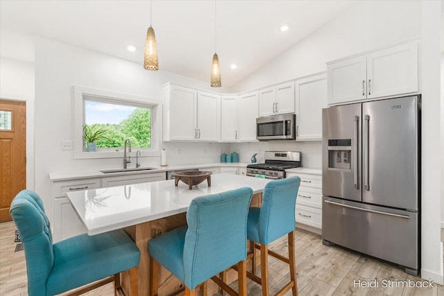 1200 Iroquois Trl, Hastings, MI 49058 - kitchen with appliances with stainless steel finishes, a sink, light wood-style flooring, light countertops, and white cabinetry