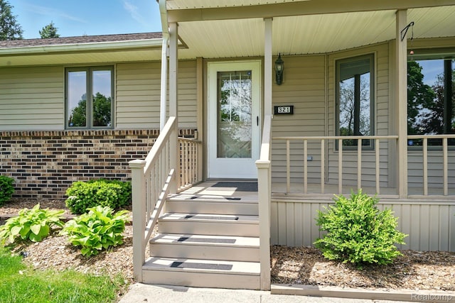 321 Myers Rd, Lapeer, MI 48446 - property entrance with a porch and brick siding