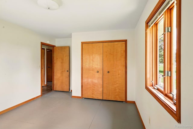 321 Myers Rd, Lapeer, MI 48446 - unfurnished bedroom with baseboards, a closet, and concrete flooring