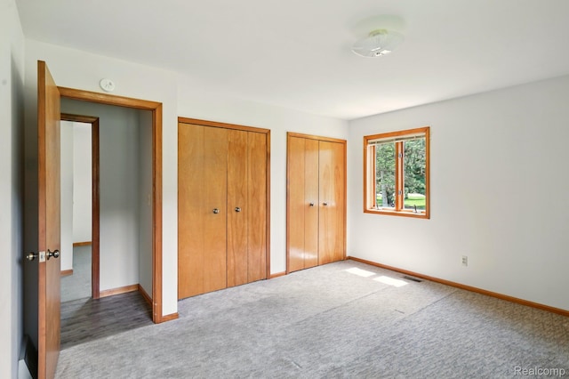 321 Myers Rd, Lapeer, MI 48446 - unfurnished bedroom with multiple closets, carpet floors, and baseboards
