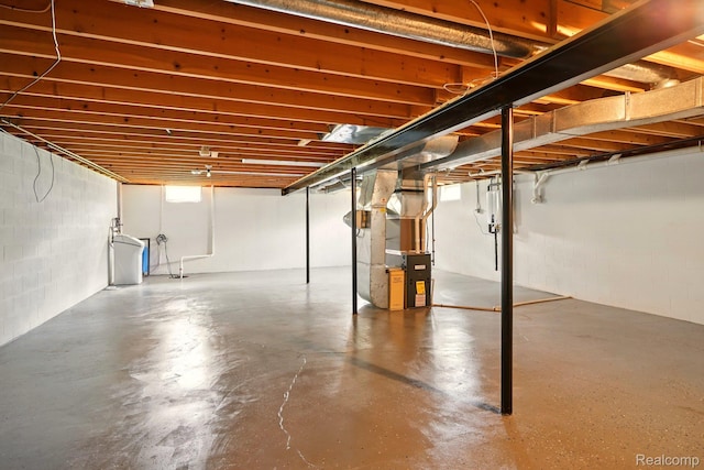 321 Myers Rd, Lapeer, MI 48446 - unfinished below grade area featuring heating unit, concrete block wall, and a water softener system