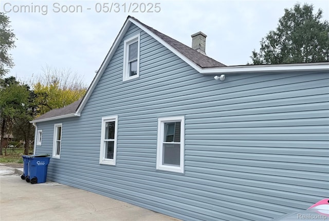 2995 Alvina Ave, Warren, MI 48091 - view of property exterior with a chimney and a patio