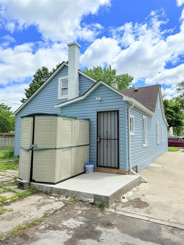 2995 Alvina Ave, Warren, MI 48091 - rear view of house featuring a chimney and roof with shingles