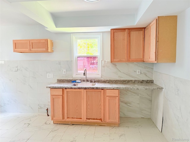2995 Alvina Ave, Warren, MI 48091 - kitchen with a sink, tile walls, light marble finish flooring, light countertops, and a wainscoted wall