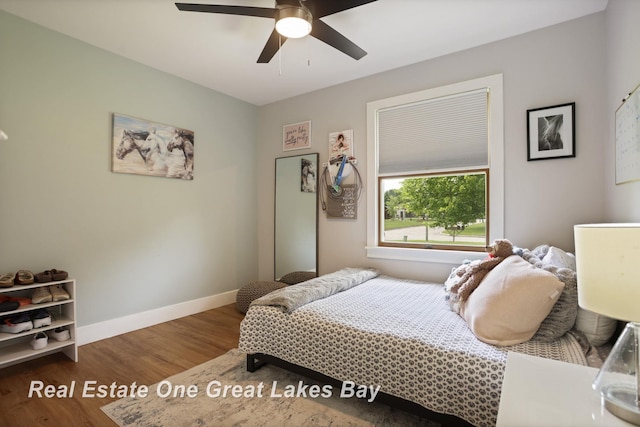 4936 Frontier Ln, Saginaw, MI 48603 - bedroom with wood finished floors, baseboards, and ceiling fan