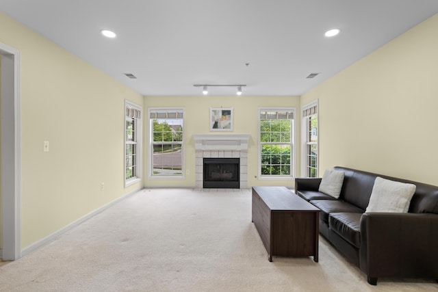28067 Carlton Way Dr, Novi, MI 48377 - living area featuring light colored carpet, a fireplace, healthy amount of natural light, recessed lighting, and baseboards