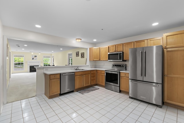 28067 Carlton Way Dr, Novi, MI 48377 - kitchen featuring stainless steel appliances, light countertops, open floor plan, a sink, and recessed lighting