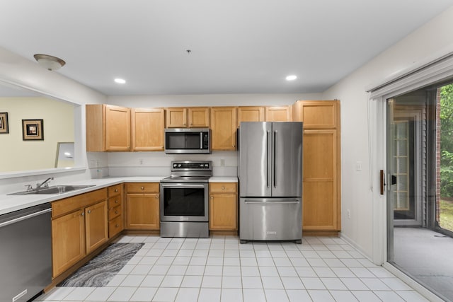 28067 Carlton Way Dr, Novi, MI 48377 - kitchen featuring stainless steel appliances, a sink, light countertops, light tile patterned floors, and recessed lighting