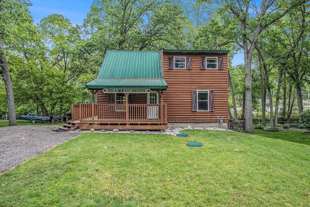 283 S Fremont Rd, Coldwater, MI 49036 - view of front of house with a front lawn, metal roof, covered porch, and view of scattered trees