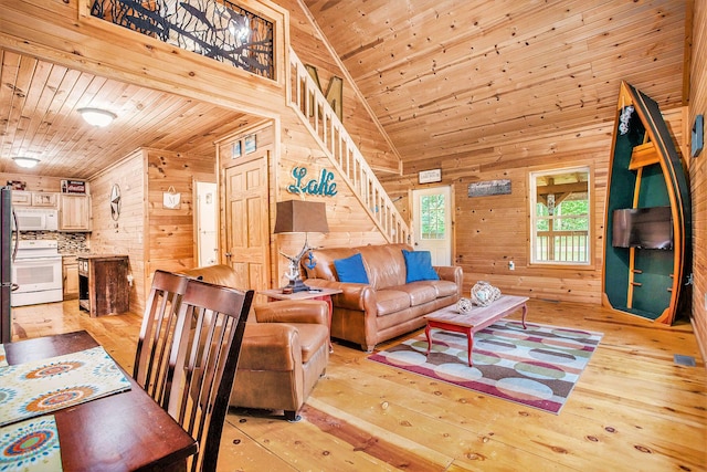 283 S Fremont Rd, Coldwater, MI 49036 - living area with wooden walls, light wood-style flooring, wood ceiling, stairs, and high vaulted ceiling