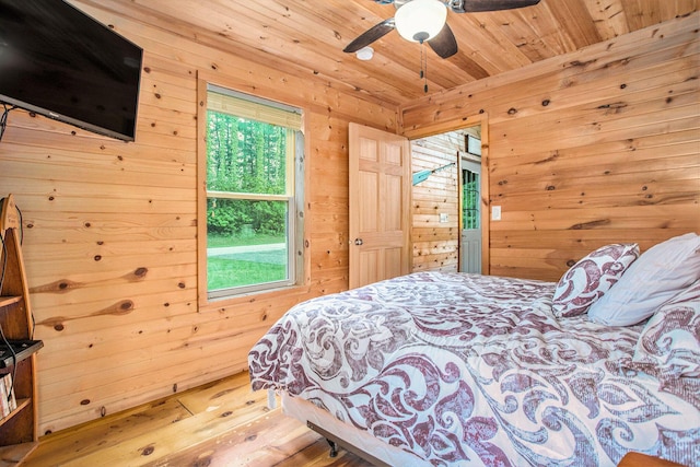 283 S Fremont Rd, Coldwater, MI 49036 - bedroom with wooden walls, hardwood / wood-style floors, wooden ceiling, and a ceiling fan
