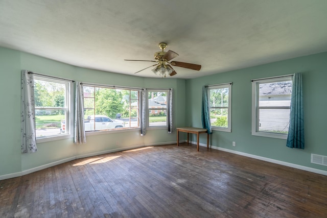 428 Orchard Ave, Muskegon, MI 49442 - unfurnished room featuring dark wood-type flooring, a ceiling fan, and baseboards