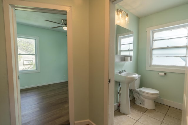 428 Orchard Ave, Muskegon, MI 49442 - half bathroom featuring toilet, a ceiling fan, baseboards, a sink, and tile patterned flooring