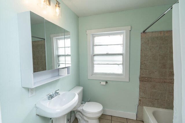 428 Orchard Ave, Muskegon, MI 49442 - full bathroom featuring toilet, tile patterned flooring, a sink, shower / tub combination, and baseboards