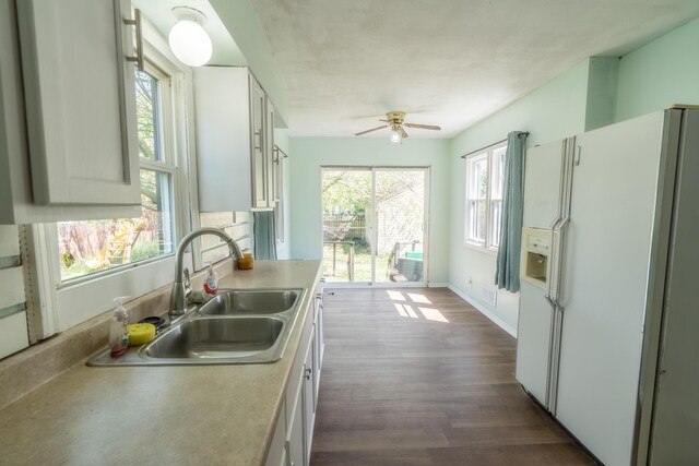 428 Orchard Ave, Muskegon, MI 49442 - kitchen featuring white fridge with ice dispenser, a sink, ceiling fan, light countertops, and white cabinetry