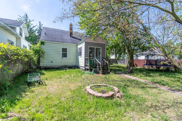 428 Orchard Ave, Muskegon, MI 49442 - rear view of house featuring a trampoline and a chimney