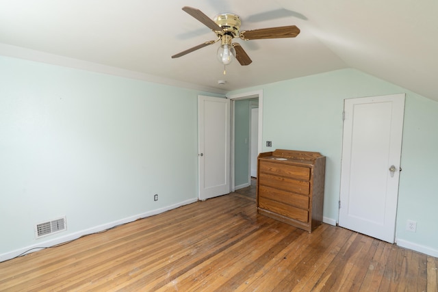 428 Orchard Ave, Muskegon, MI 49442 - unfurnished bedroom featuring wood-type flooring, baseboards, vaulted ceiling, and a ceiling fan