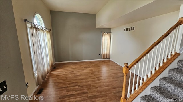 540 Clairpointe Woods Dr, Detroit, MI 48215 - foyer entrance featuring wood finished floors, stairway, baseboards, and a towering ceiling