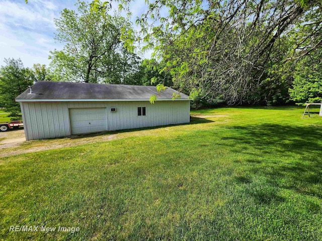 10424 S Graham Rd, Saint Charles, MI 48655 - view of grassy yard with an outbuilding, a detached garage, and driveway