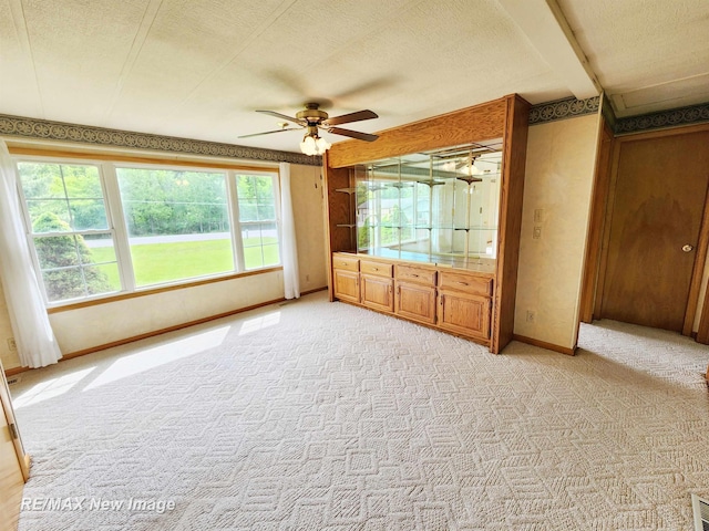 10424 S Graham Rd, Saint Charles, MI 48655 - unfurnished bedroom featuring light colored carpet, a textured ceiling, baseboards, and ceiling fan