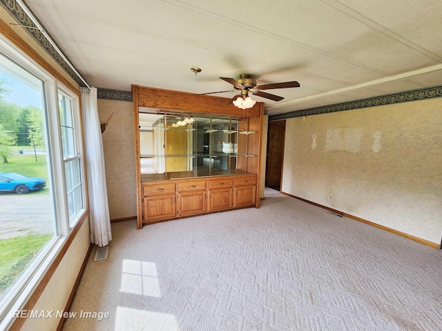 10424 S Graham Rd, Saint Charles, MI 48655 - unfurnished living room with light colored carpet, ceiling fan, baseboards, and a textured wall