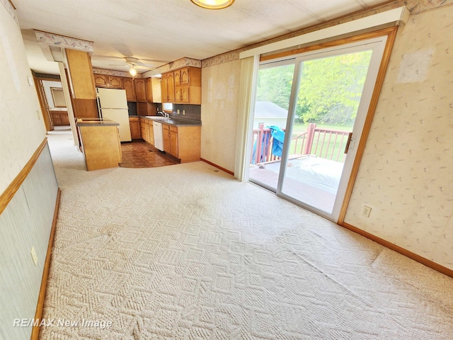 10424 S Graham Rd, Saint Charles, MI 48655 - kitchen featuring white appliances, a sink, carpet, wallpapered walls, and dark countertops