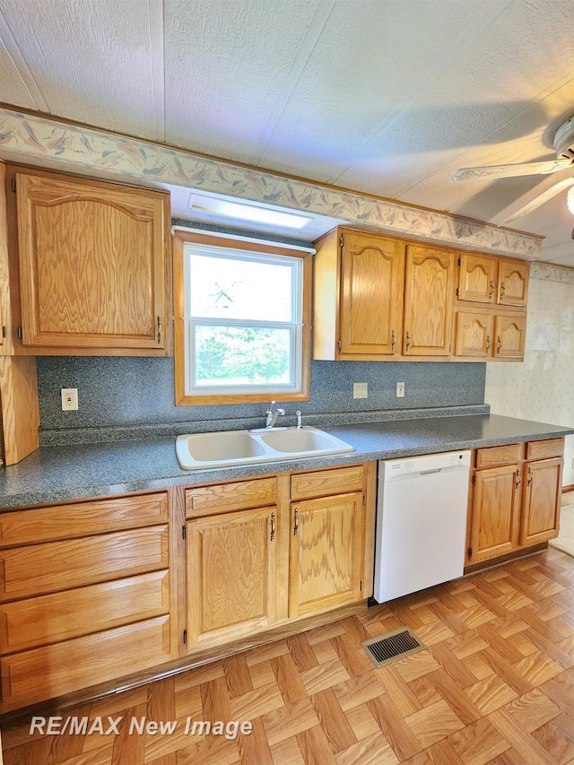10424 S Graham Rd, Saint Charles, MI 48655 - kitchen with a sink, white dishwasher, ceiling fan, a textured ceiling, and dark countertops