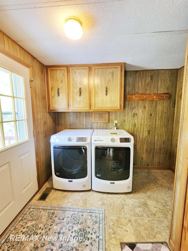 10424 S Graham Rd, Saint Charles, MI 48655 - washroom featuring cabinet space, wood walls, separate washer and dryer, and a textured ceiling