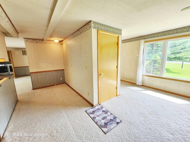10424 S Graham Rd, Saint Charles, MI 48655 - hallway with wallpapered walls, light colored carpet, and a wainscoted wall