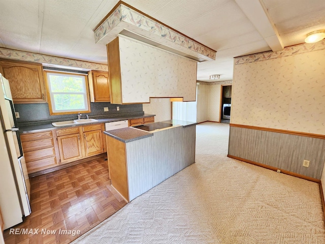 10424 S Graham Rd, Saint Charles, MI 48655 - kitchen featuring wallpapered walls, a sink, a wainscoted wall, white appliances, and dark countertops