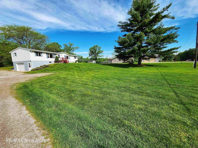 10424 S Graham Rd, Saint Charles, MI 48655 - view of grassy yard featuring an attached garage and dirt driveway