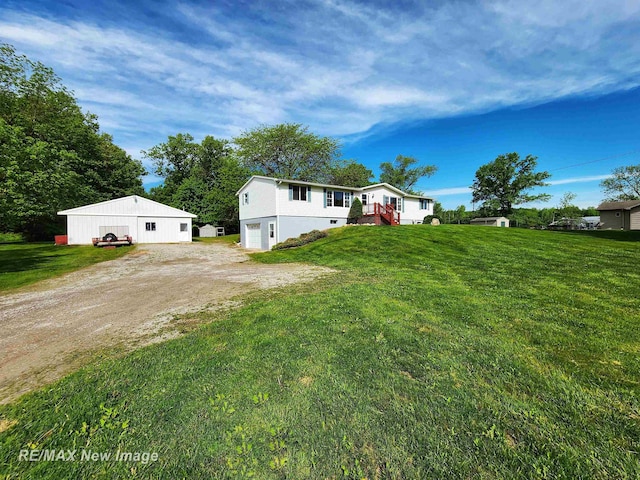 10424 S Graham Rd, Saint Charles, MI 48655 - view of grassy yard featuring driveway and a garage