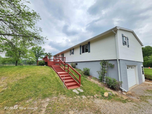 10424 S Graham Rd, Saint Charles, MI 48655 - rear view of property featuring stairway, a garage, a lawn, and a deck