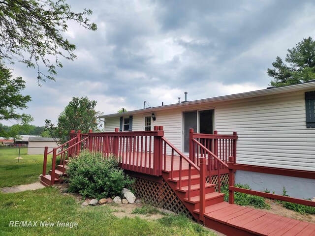 10424 S Graham Rd, Saint Charles, MI 48655 - rear view of house featuring a wooden deck, a yard, and stairs