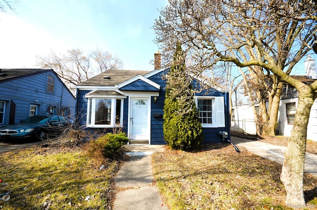 22813 Rosalind Ave, Eastpointe, MI 48021 - bungalow-style house featuring a chimney and a shingled roof