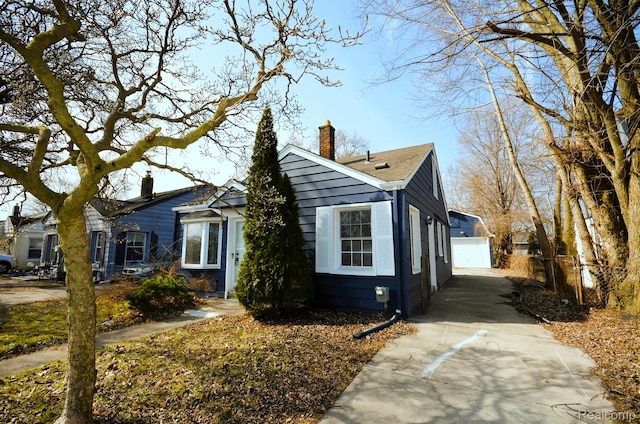 22813 Rosalind Ave, Eastpointe, MI 48021 - view of front of home featuring a chimney, a garage, an outbuilding, and a shingled roof