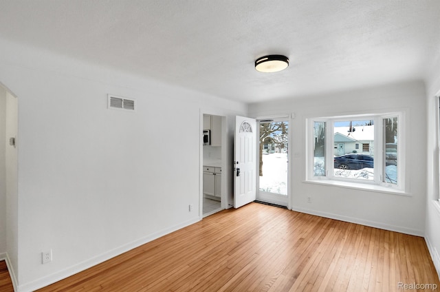 22813 Rosalind Ave, Eastpointe, MI 48021 - empty room with light wood-style flooring, baseboards, and arched walkways