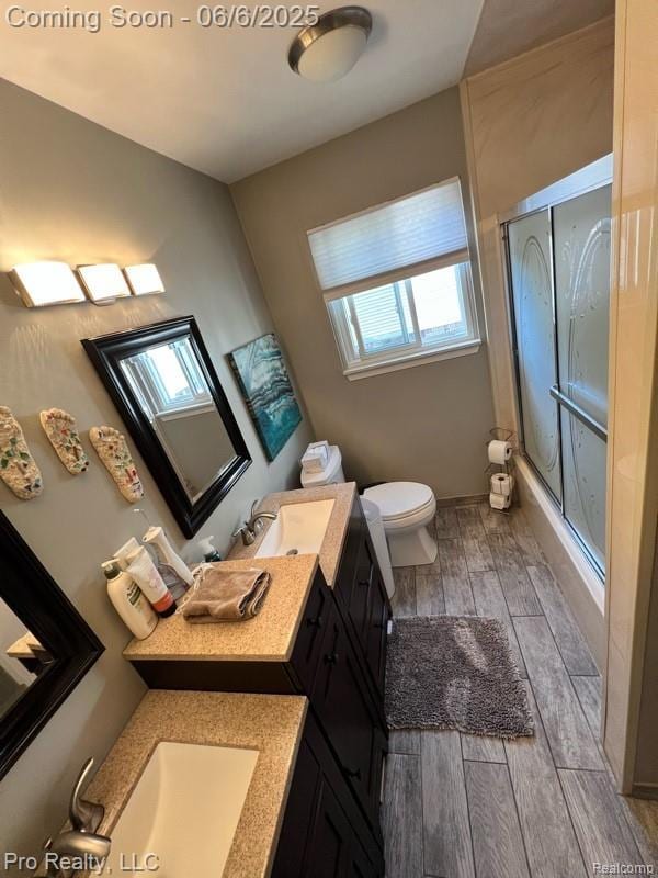 44195 Dartmouth St, Canton, MI 48188 - bathroom featuring a shower stall, wood finished floors, toilet, and vanity