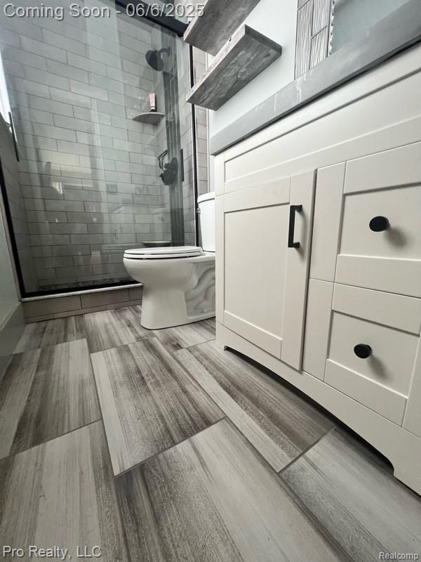 44195 Dartmouth St, Canton, MI 48188 - full bathroom with toilet, a stall shower, and wood finished floors