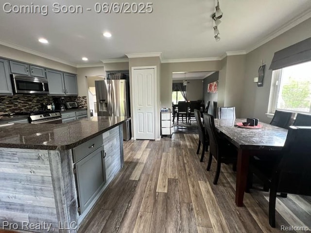 44195 Dartmouth St, Canton, MI 48188 - kitchen with appliances with stainless steel finishes, gray cabinets, dark wood-style floors, decorative backsplash, and crown molding