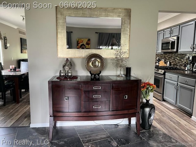 44195 Dartmouth St, Canton, MI 48188 - kitchen view of stainless steel appliances, crown molding, dark countertops, decorative backsplash, and gray cabinets