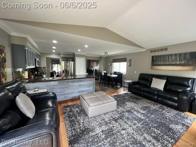 44195 Dartmouth St, Canton, MI 48188 - living area featuring wood finished floors, crown molding, lofted ceiling, and recessed lighting