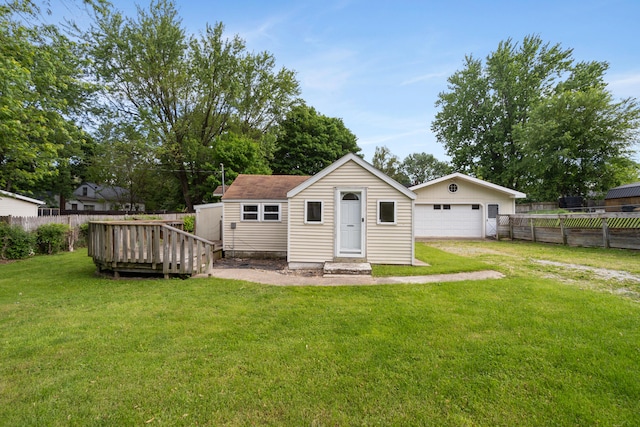 817 Annetta Ave, Jackson, MI 49203 - back of property with an outdoor structure, a garage, and a deck