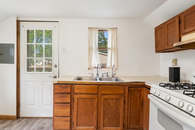817 Annetta Ave, Jackson, MI 49203 - kitchen featuring a sink, gas range gas stove, electric panel, light countertops, and brown cabinetry