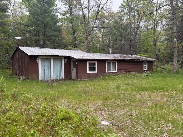 4465 E Old M-63, Luther, MI 49656 - view of front facade with a wooded view