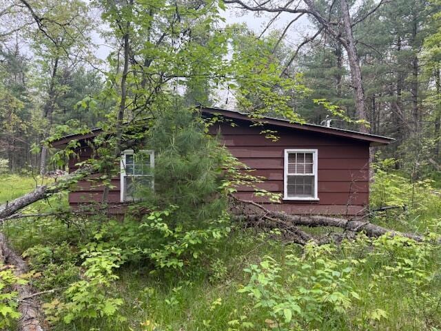 4465 E Old M-63, Luther, MI 49656 - view of side of property featuring a view of trees